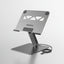 A silver metallic laptop stand with black rubber feet, shown on a light gray background with callout text highlighting features like metal hinge durability, rubber design, and ergonomic support. The brand name BENFEI is visible on the center of the stand.