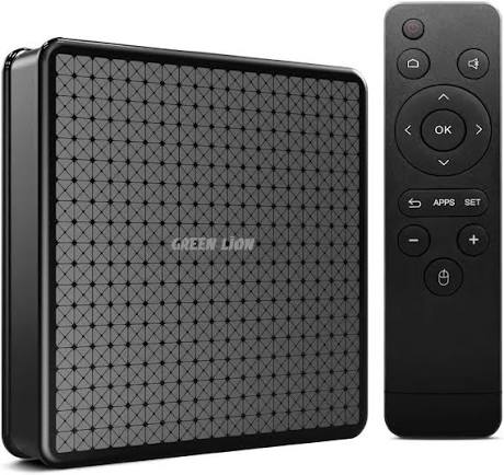 A black smart TV box with a geometric patterned front and the words GREEN LION printed on it, shown next to a matching black remote control on a white background.