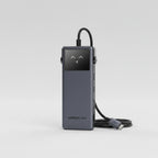 UGREEN Uno 6-in-1 USB C hub shown in a dark gray metallic finish, featuring multiple ports and a central USB-C port, set against a dark blue and purple gradient background with text callouts.