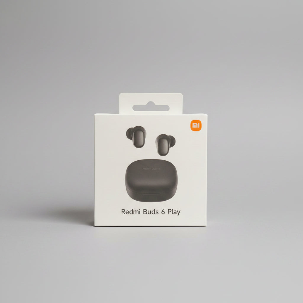 A hand wearing a black glove holds a white retail box for Redmi Buds 6 Play, showing the gray wireless earbuds and charging case illustration on the front. The Xiaomi logo is visible in the top right corner, with a dark, leafy background and pink lighting.