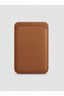 A brown leather Apple card case with an embossed Apple logo in the center, shown against a white background.