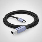 A close-up of a braided USB-C to USB-A cable with a light blue metallic connector housing and black braided cord, shown on a white background.
