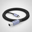 A close-up of a braided USB-C to USB-A cable with a light blue metallic connector housing and black braided cord, shown on a white background.