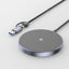 A wireless charging pad with a USB-C cable, featuring a circular gray top with a lightning bolt symbol and a metallic silver rim, shown on a white background.
