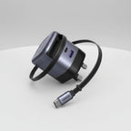 A Ugreen UK wall charger adapter with a USB-C to USB-C cable, featuring a dark gray and black design with a purple accent on the USB-A port.