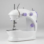 A compact white electric sewing machine with purple accents, shown on a white background with a small inset image demonstrating it sewing pink fabric under a bright light.