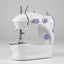 A compact white electric sewing machine with purple accents, shown on a white background with a small inset image demonstrating it sewing pink fabric under a bright light.