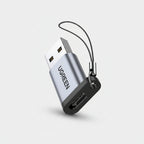 UGREEN USB flash drive adapter with a silver aluminum body, black connector base, and a black lanyard keychain, shown on a plain white background.