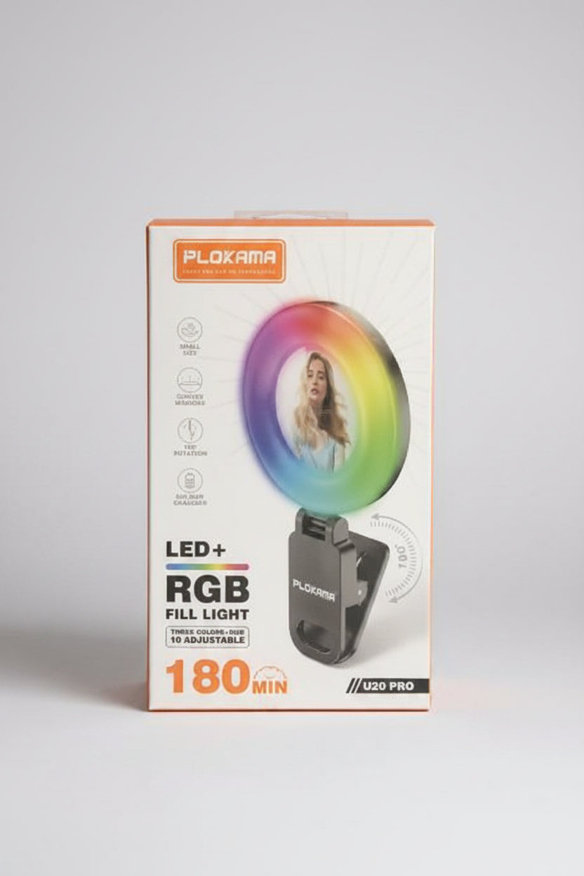 Plokama USB Pro LED+ RGB Fill Light in its original retail packaging, displayed on a reflective surface in a store setting.