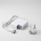 White wall charger adapter with a coiled cable, USB-C connector, and UK three-pin plug on a plain white background.